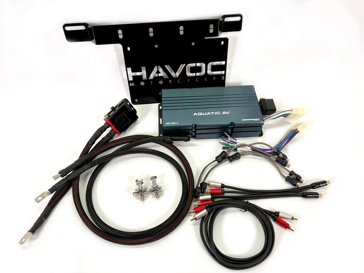 Havoc Motorcycles Aquatic AV marine audio amplifier kit with black metal mounting bracket, blue amplifier box, black cables, red and white RCA connectors, and mounting hardware on a white background.